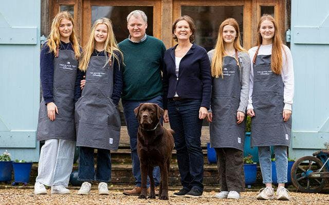 Jon and Sarah Nelson with their four daughters and the distillery dog