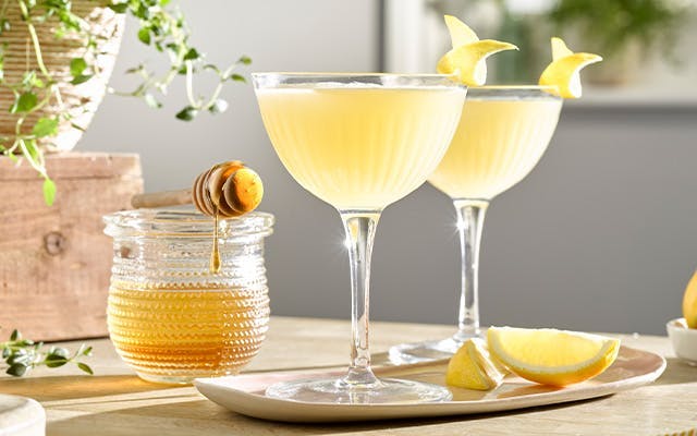 Bee's Knees Spring Cocktail Recipe in a coupe glass with lemon garnish