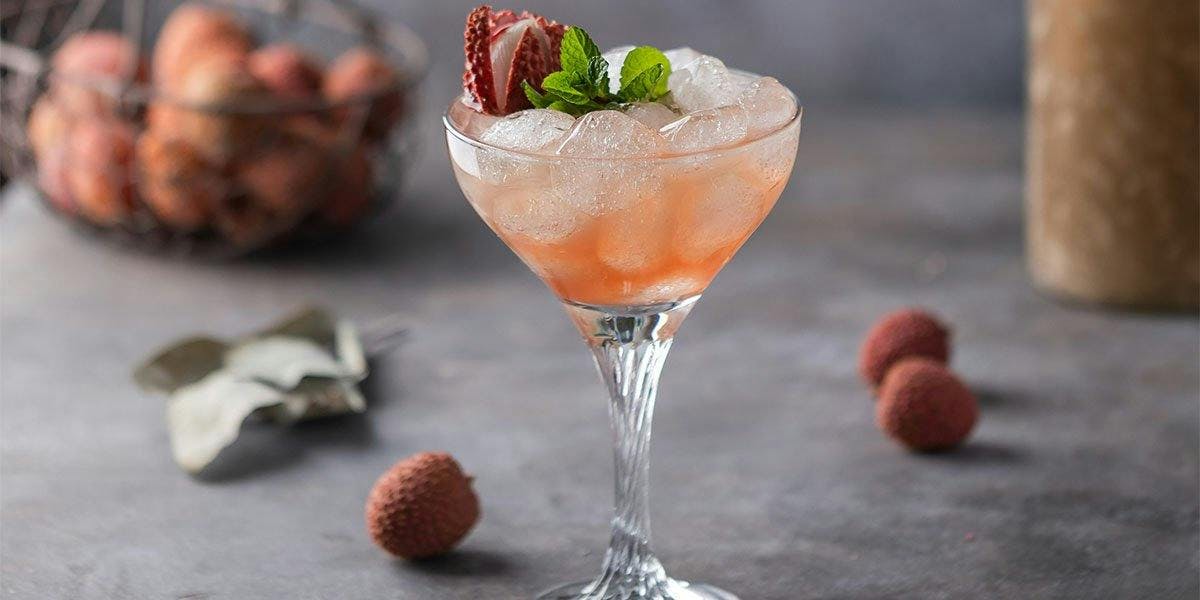 Lychee, sparkling white wine and gin come together in this stunning Spritz cocktail recipe! 
