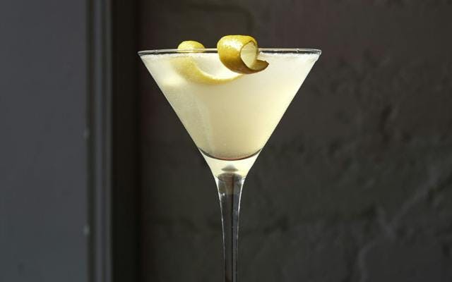 Gin Sour white cocktail with lemon zest twist garnish