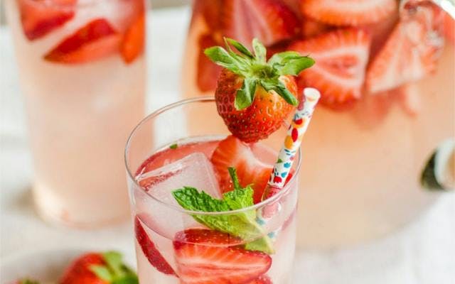 Occitan strawberry gin smash with mint and straw over ice