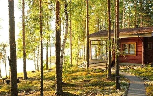 Summer log lodge cabin by the lake in the forrest