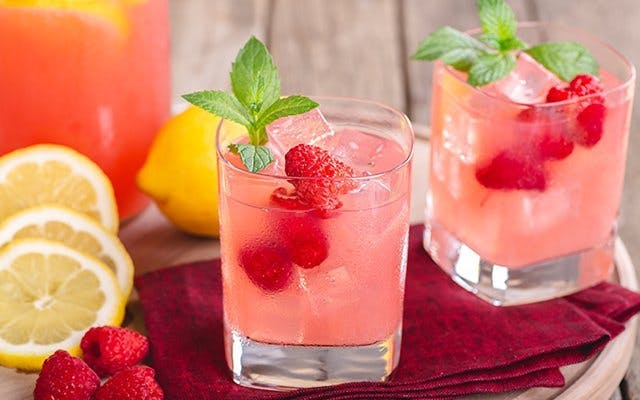 gin and raspberry cocktail with mint sprig