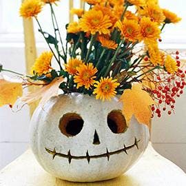 Less freaky and more fabulous - why not turn your pumpkin into an autumnal flower display? (Via HubPages)