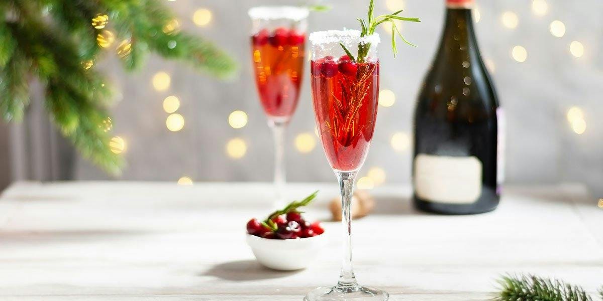 Enjoy a bit of Christmas fizz with the Yuletide Spritz: it's made with gin, Cointreau, cranberries and prosecco - YUM!