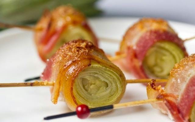 Delicious bacon wrapped artichoke hearts on skewers