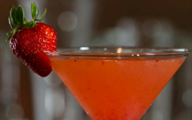 Red strawberry cocktail with strawberry garnish