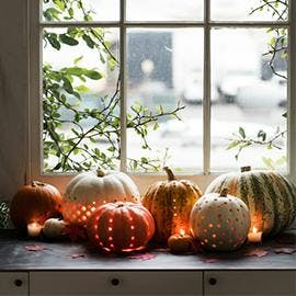 Pretty for a mantelpiece or windowsill! Carve a few polka dot holes into your pumpkin in various designs and let that twinkly light shine through! (Via Delta-Breezes)