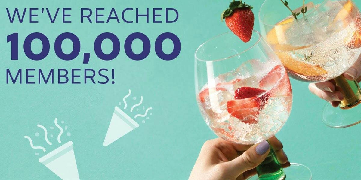 Two gin glasses clinking and text saying "We've reached 100,000 members!"