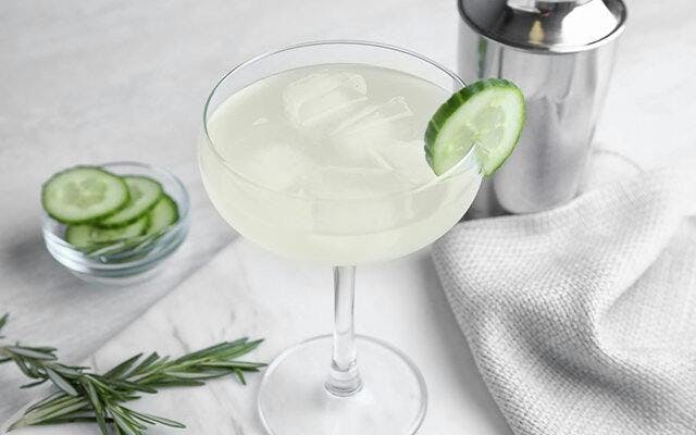 Occitanian Occitan Gin cocktail with cucumber and rosemary garnishes