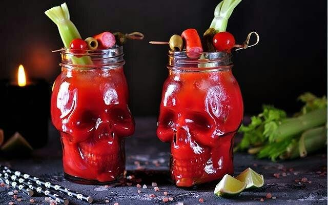 Halloween bloody mary cocktail in a skull glass