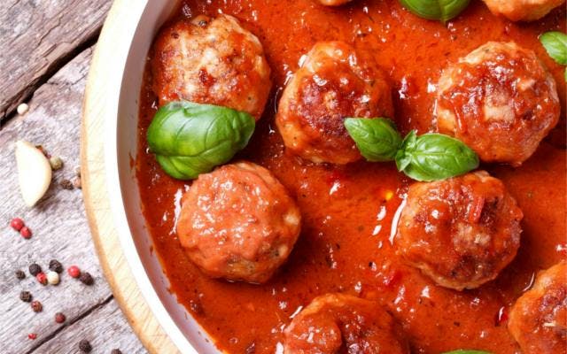 Aperitivo Gin Party Meatballs covered in tomato sauce with basil yummy Italian food