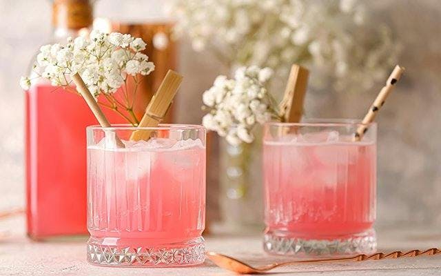 Floral garnish on cocktail