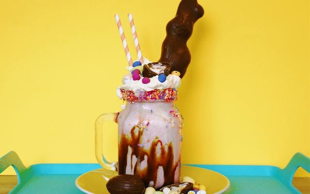 Gin Easter Freakshake with chocolate cream whipped cream lindt bunny smarties easter eggs and mini eggs and sprinkles