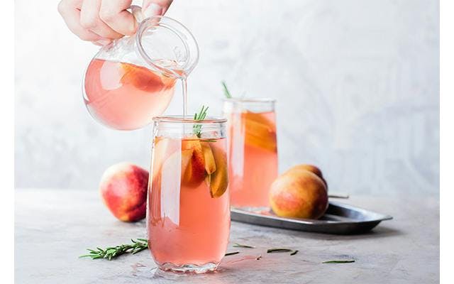 Pink gin and peach lemonade is a delightful summer cocktail