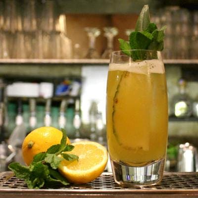 Pietro Punch yellow cocktail with pineapple and lemon and mint