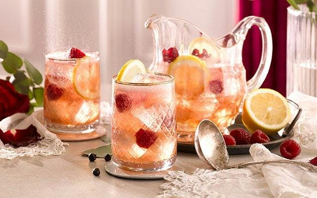 Sparkling rose sangria punch recipe with gin, creme de mure, lemon juice and raspberries