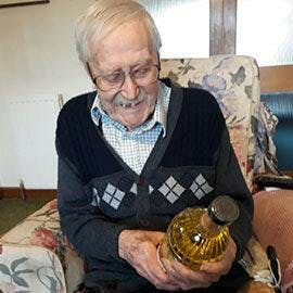 Donald opens his bottle of Six Bells Gin, our little gift for him on his 100th birthday