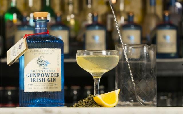 Gunpowder Irish Gin cocktail on a bar with lemon garnish