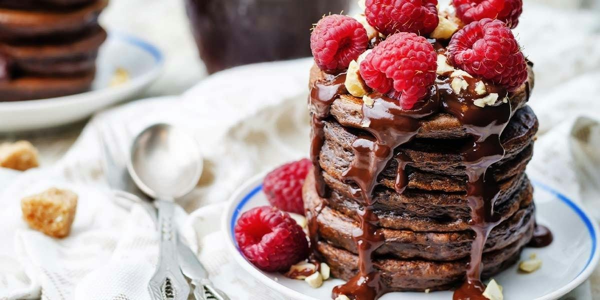 Fluffy chocolate banana pancakes with chocolate salted caramel sauce and sloe gin berries! 