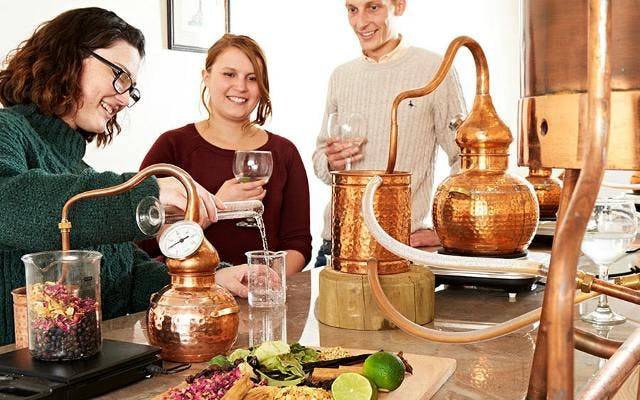 Gin making at a distillery with copper still and botanicals