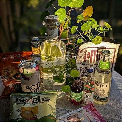 A well lit photo showcasing all of August's Gin of the Month box products