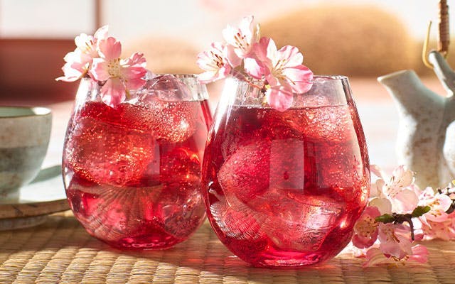 A delicious, red Wabi Sabi Sakura Gin cocktail with cherry blossom flowers 
