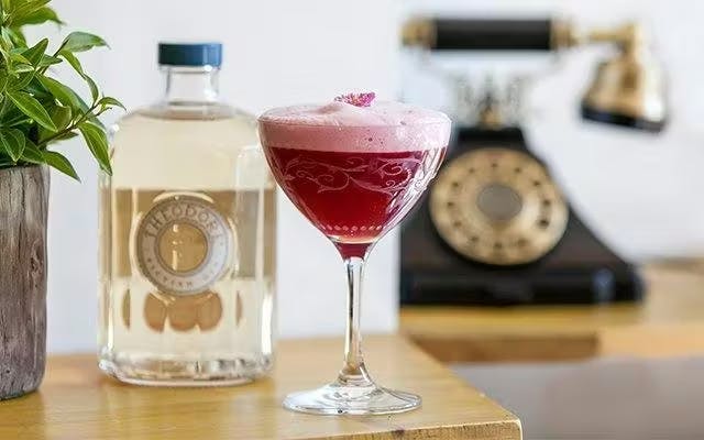 Dark pink foamy cocktail in a coupe glass 