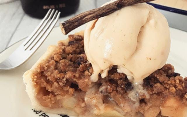 Gin Apple Pie with vanilla ice cream and cinnamon stick topping