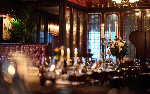 Inside the ship tavern pub in london with candles and glasswear