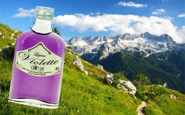 Liqueur de violette creme minature with mountains in backgrounds